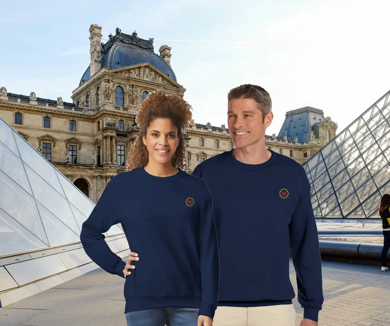 Couple wearing "Show the ❤️ for EU" sweatshirts in front of the Louvre, Paris