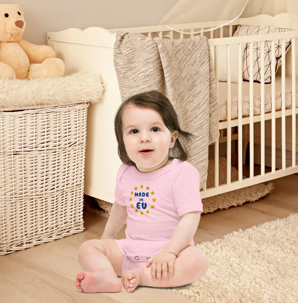Baby Wearing Pink "Made in EU" Embroidered Bodysuit in a Nursery